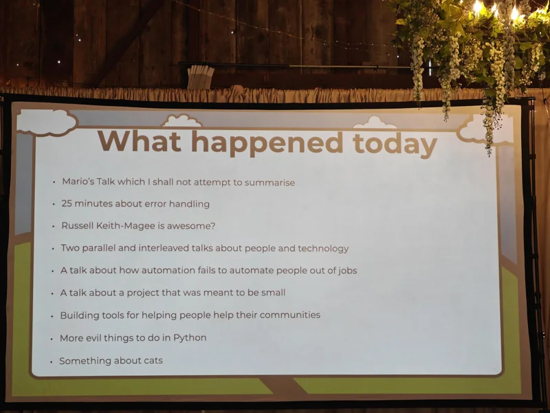 Closeup of the projector screen reading 'What happened today' and a one line summary of all the talks that day.